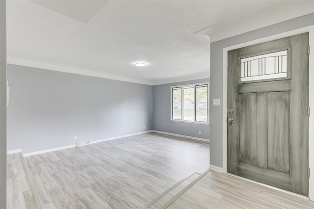 foyer featuring light hardwood / wood-style flooring and ornamental molding