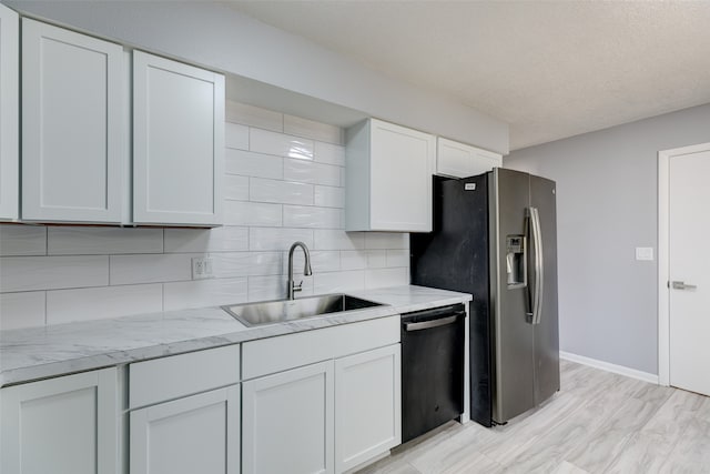 kitchen featuring stainless steel appliances, sink, light wood-type flooring, and white cabinets