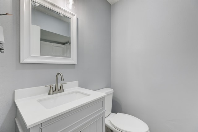 bathroom featuring toilet and vanity