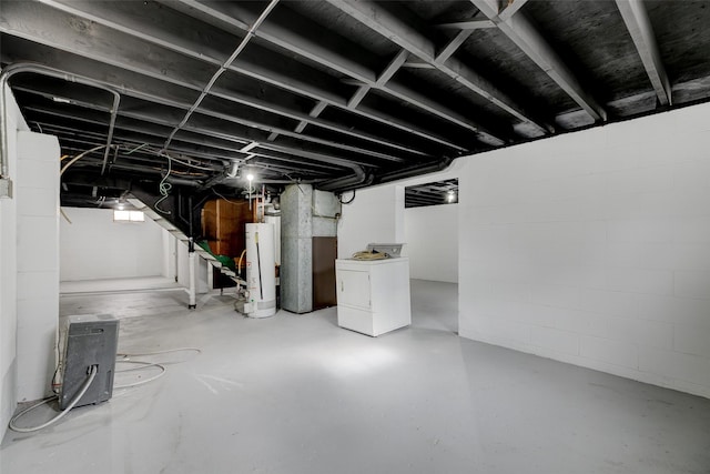 unfinished below grade area with gas water heater and washer / dryer