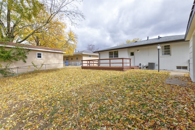 view of yard with a wooden deck and central air condition unit