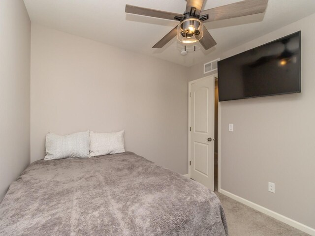 unfurnished bedroom featuring a ceiling fan, carpet, and visible vents