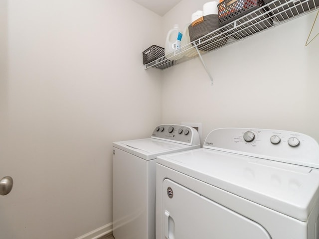 laundry room with washing machine and dryer, laundry area, and baseboards