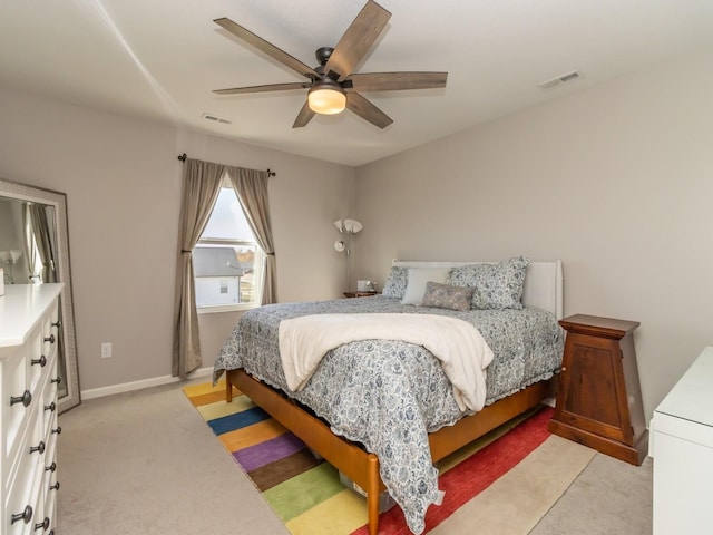 bedroom featuring light carpet, ceiling fan, visible vents, and baseboards