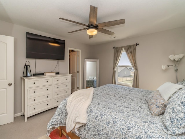 bedroom featuring light carpet and ceiling fan