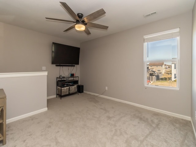 unfurnished living room featuring carpet floors, visible vents, ceiling fan, and baseboards