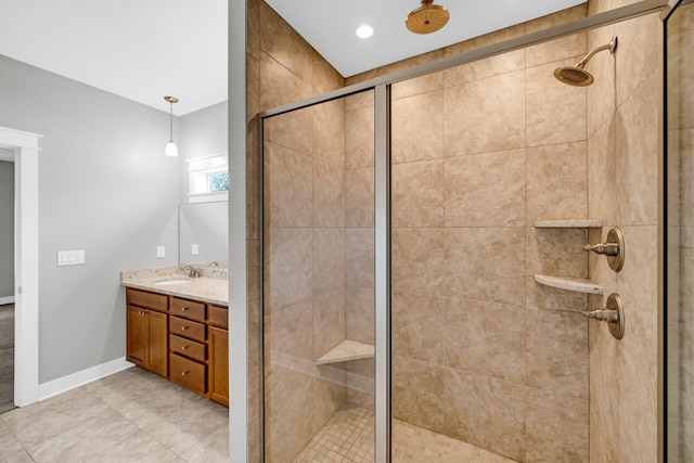 bathroom with vanity, walk in shower, and tile patterned floors