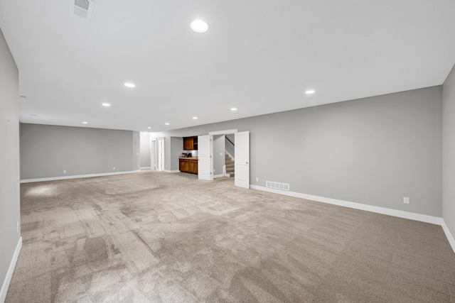 unfurnished living room with light carpet