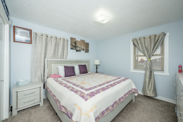 carpeted bedroom featuring a textured ceiling