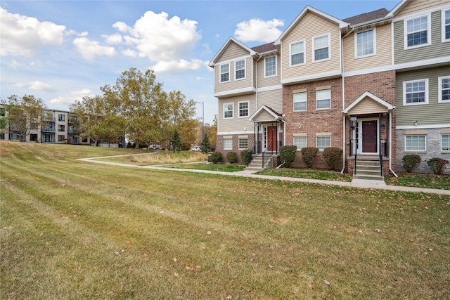 townhome / multi-family property with a front yard