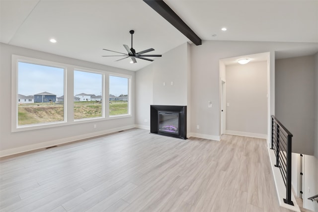 unfurnished living room with vaulted ceiling with beams, ceiling fan, and light wood-type flooring