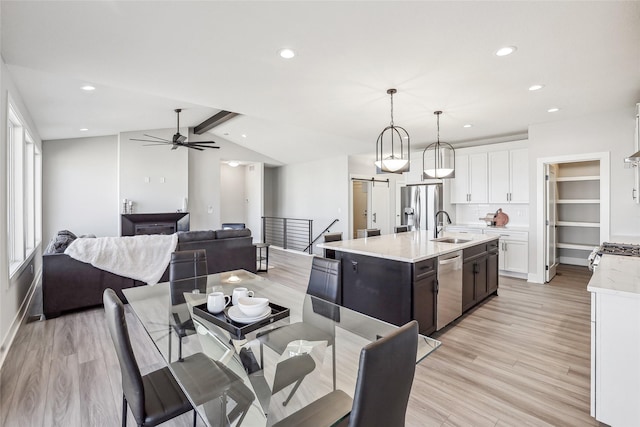 dining area with light wood-style floors, recessed lighting, ceiling fan, and lofted ceiling with beams