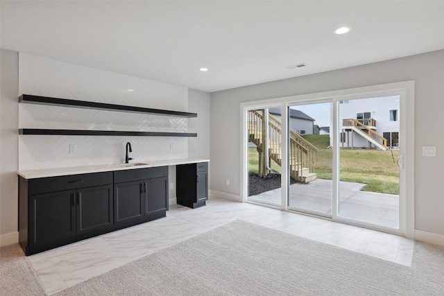 bar featuring visible vents, a sink, marble finish floor, backsplash, and recessed lighting