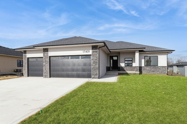 prairie-style home featuring a garage and a front yard