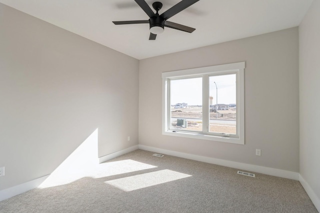 spare room featuring ceiling fan and carpet