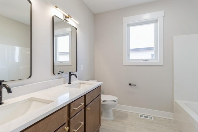 bathroom featuring vanity and toilet