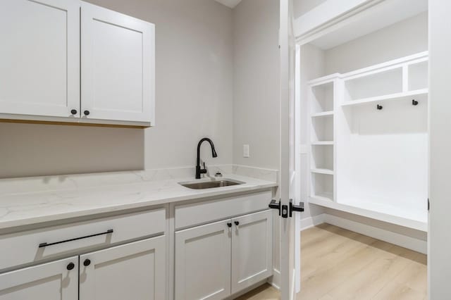 washroom with sink and light hardwood / wood-style floors