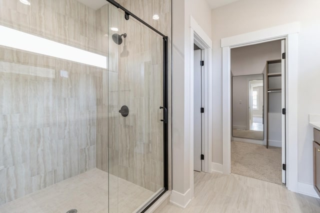 bathroom featuring vanity and an enclosed shower