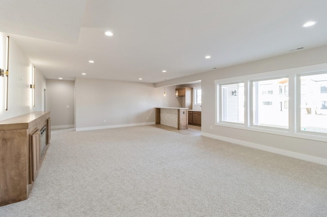 unfurnished living room featuring light colored carpet