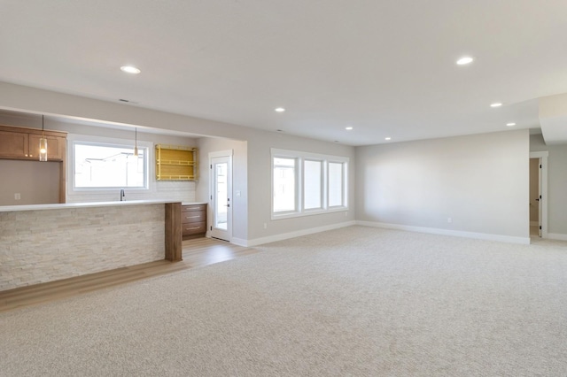 unfurnished living room with light colored carpet