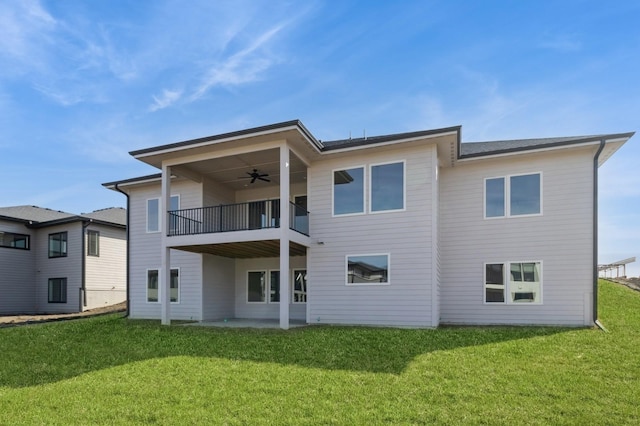 back of house featuring a balcony, a yard, ceiling fan, and a patio area