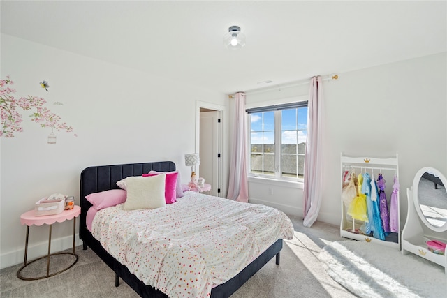 bedroom with light carpet and a closet