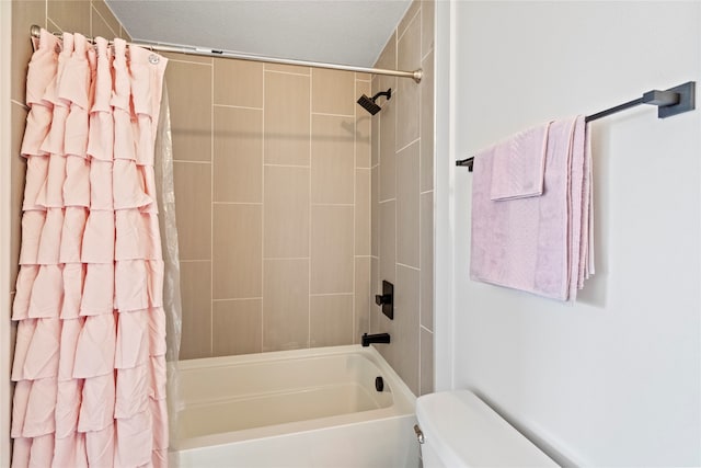 bathroom with toilet and shower / bath combo with shower curtain