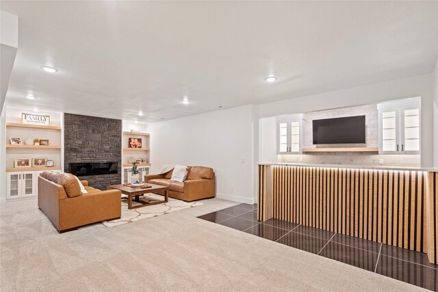 carpeted living room with built in shelves and a fireplace