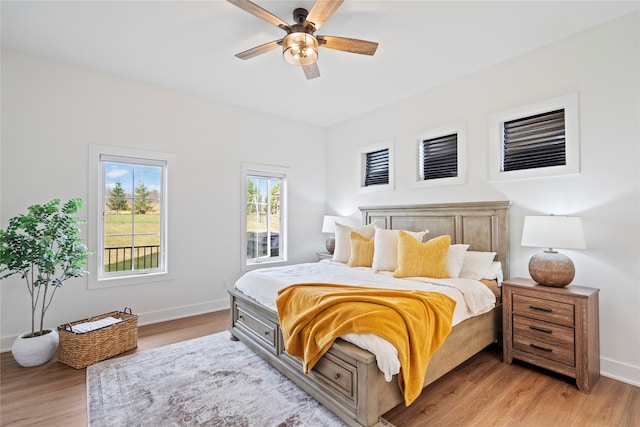 bedroom with ceiling fan and light hardwood / wood-style floors