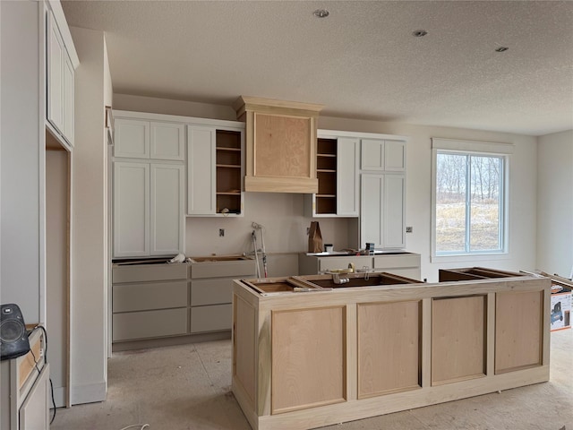 kitchen featuring a center island and a textured ceiling