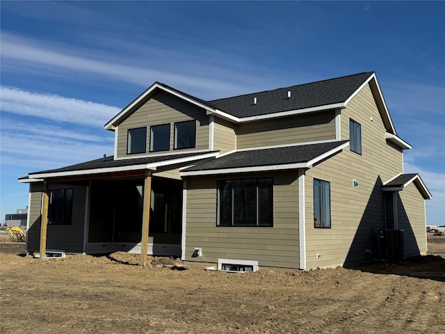 rear view of house featuring a sunroom