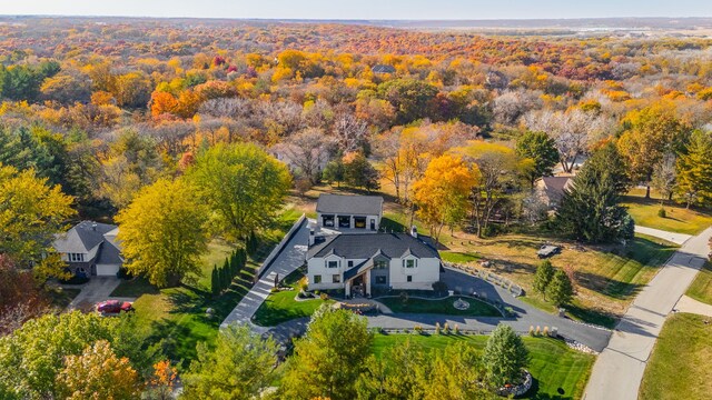 birds eye view of property featuring a wooded view