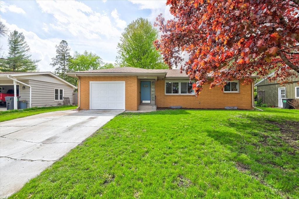 single story home with a front yard, a garage, and a carport