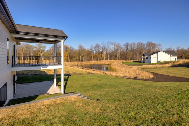 view of yard featuring a patio area and a water view