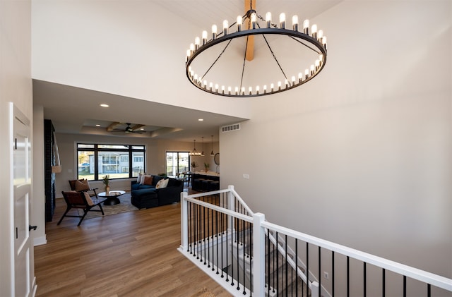 hall featuring a notable chandelier and hardwood / wood-style flooring