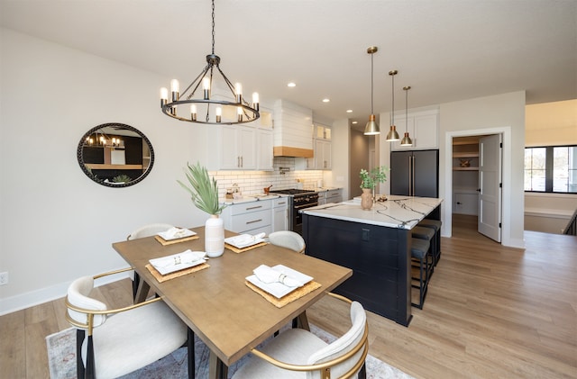 dining area featuring light hardwood / wood-style flooring and a chandelier