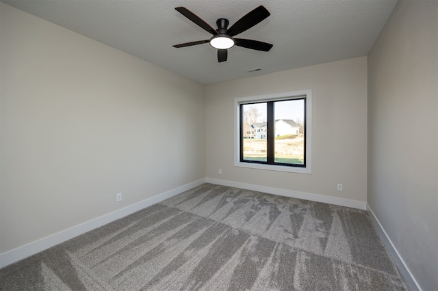 unfurnished room featuring light carpet, a textured ceiling, and ceiling fan