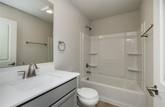 full bathroom with vanity, toilet,  shower combination, and wood-type flooring