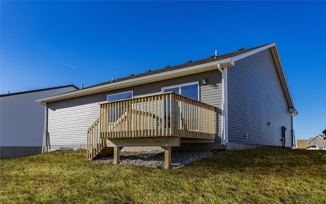 back of property with a wooden deck and a yard