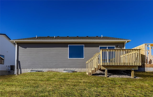 rear view of house with a yard, central AC, and a deck