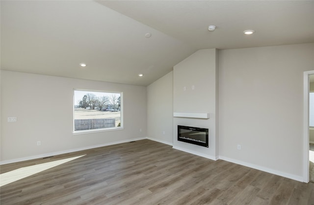 unfurnished living room with lofted ceiling and light hardwood / wood-style flooring