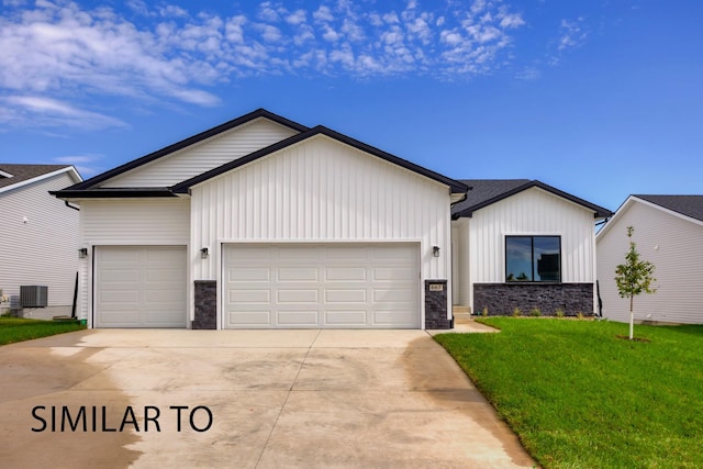 view of front facade featuring central AC, a front lawn, and a garage