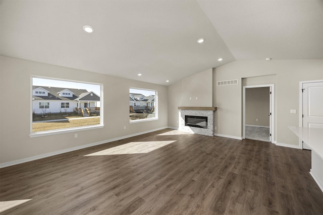 9748 Thorton Dr, Johnston, IA 50131 - unfurnished living room with vaulted ceiling, a fireplace, dark wood finished floors, baseboards, and recessed lighting