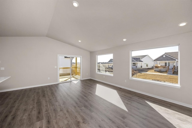 9748 Thorton Dr, Johnston, IA 50131 - empty room with healthy amount of natural light, lofted ceiling, dark wood-style floors, recessed lighting, and baseboards