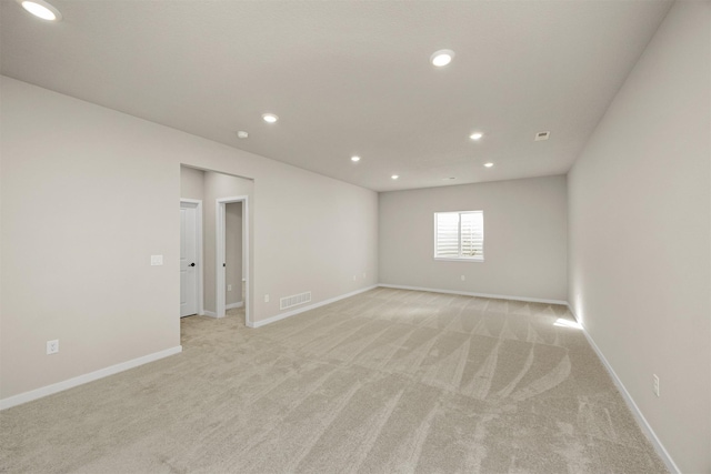 9748 Thorton Dr, Johnston, IA 50131 - empty room featuring light colored carpet, recessed lighting, and baseboards