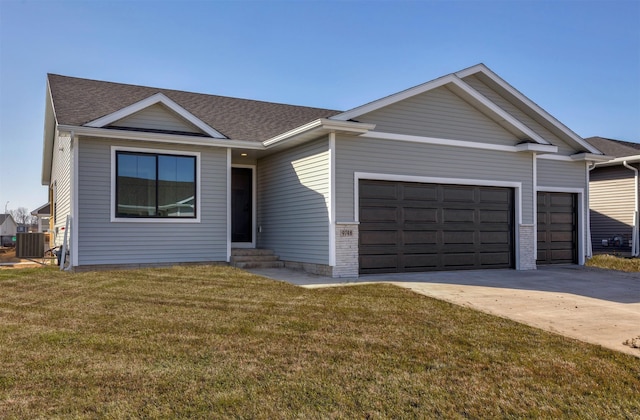 9748 Thorton Dr, Johnston, IA 50131 - ranch-style home featuring a garage, entry steps, concrete driveway, a front yard, and roof with shingles