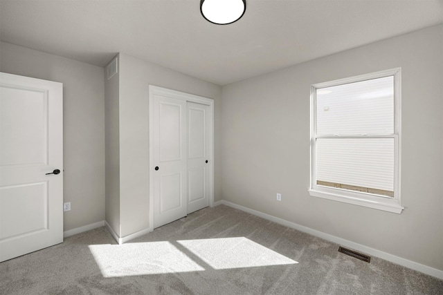 9748 Thorton Dr, Johnston, IA 50131 - unfurnished bedroom with carpet, baseboards, and a closet