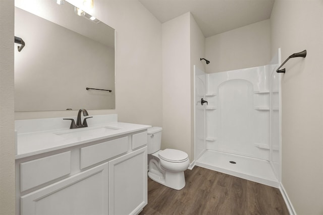 9748 Thorton Dr, Johnston, IA 50131 - bathroom with a shower, wood finished floors, toilet, vanity, and baseboards