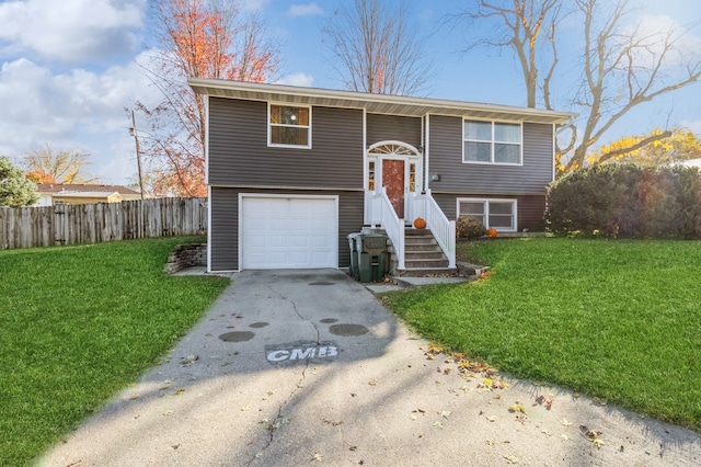 split foyer home featuring a front lawn and a garage