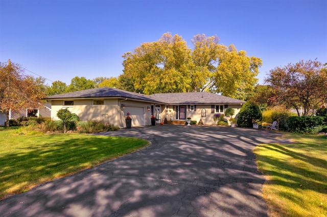 view of front of house with a front yard and a garage